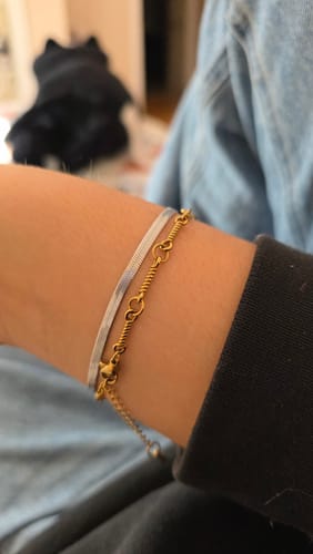 Customer wearing the Sarya Snake Chain Silver Bracelet layered with a dainty gold bracelet on their wrist.