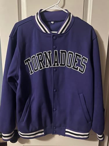 Reviewer's custom purple varsity jacket with 'TORNADOES' stitched across the front.