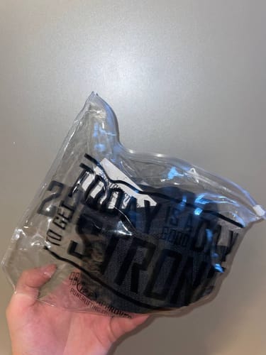 Customer holding the Stealth Black Wrist Wraps in their original packaging.