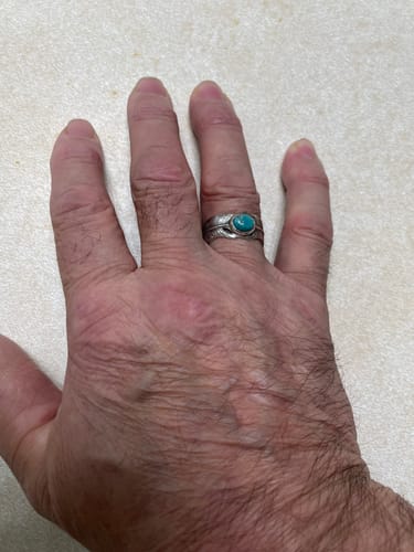 Customer's hand showing the fit of the sterling silver Feather Turquoise Ring on their finger.