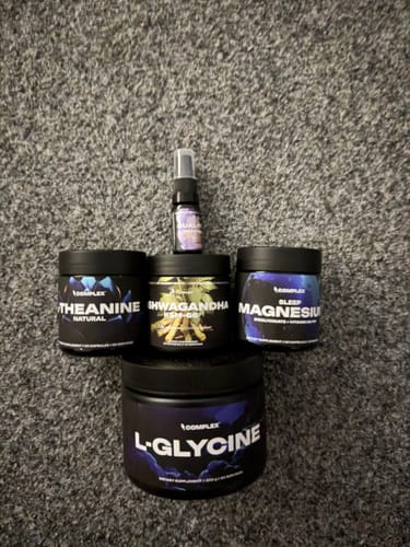 Customer's Better Sleep Bundle products, including L-Glycine and Magnesium, arranged on a grey carpet.