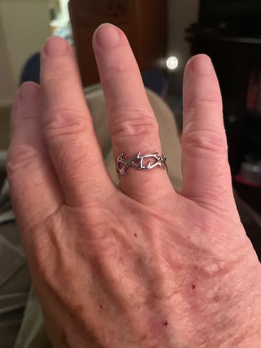 Close-up of a customer's hand wearing the silver Crown of Thorns Ring.
