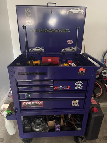 A customer's Godzilla sticker applied to the drawer of a purple tool cart.