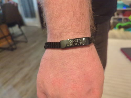 Close-up of a customer's wrist wearing the black Double Row Box Link ID Bracelet with an engraved plate.