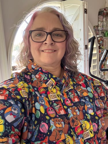Reviewer smiling in the colorful Five Nights at Freddy's 'Fantasy and Fun' short sleeve shirt.