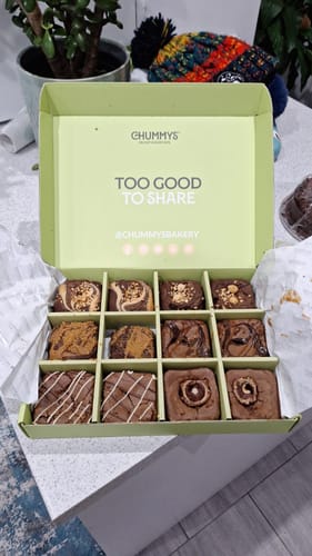 Reviewer's open Postal Brownie Box, displaying twelve delicious and assorted brownies inside.