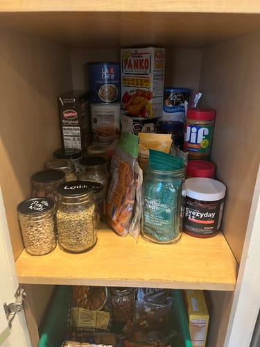 Customer's organized pantry shelf with food stored in multiple mason jars.