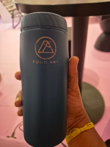 Reviewer holds a blue thermal soup flask, ready for their daily GetFit soup.