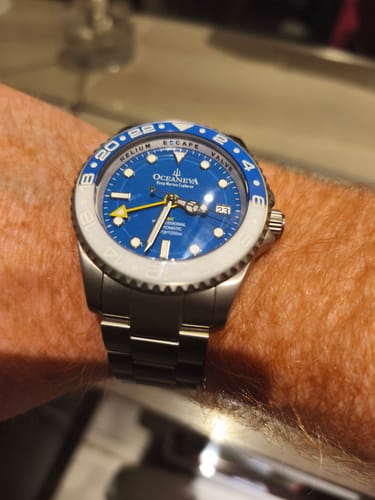 Customer's Oceaneva GMT Titanium watch on-wrist, highlighting the blue dial and blue and white ceramic bezel.