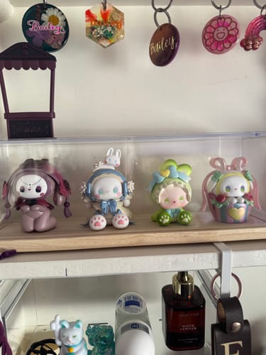 Reviewer's collection of four different Emma Secret Forest Perfume Discovery Series figures displayed on a shelf.