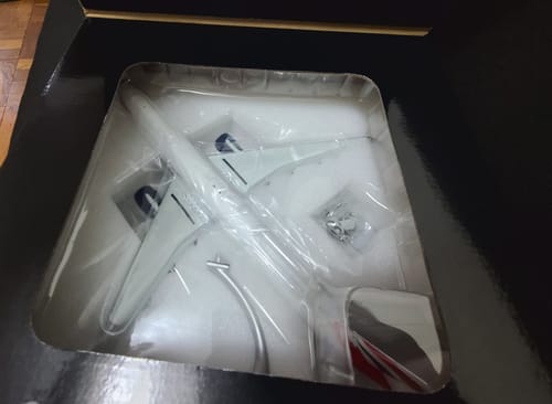 Customer's GEMINI200 British 777-300ER model airplane inside its original black packaging with a clear window.