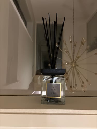 Customer's elegant Luxury Square Diffuser with black reeds, displayed on a window ledge in their home.