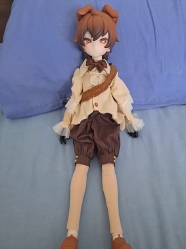 Customer's UF Doll Drink Series action figure lying on a blue surface, showing its detailed tan and brown outfit.