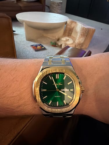 Customer wearing the Lucky Fours® Caspian watch on their wrist, showing its green dial and two-tone metal finish.