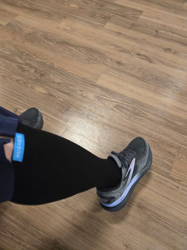 Reviewer showing the fit of the black Performance Eucalyptus Compression Socks on their leg, with the blue top band visible.