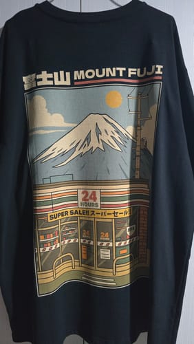 Customer's black Fuji Mart T-Shirt showing the detailed back graphic of Mount Fuji over a convenience store.