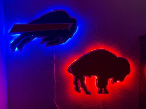 Customer's two 3D metal wall art logos with bright blue and red backlighting.