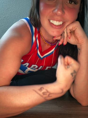 Reviewer smiling confidently to show their bright Pop On Veneers.