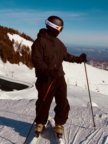 Customer wearing the dark Coffee Techwear Insulated Snow Anorak on a snowy mountain.
