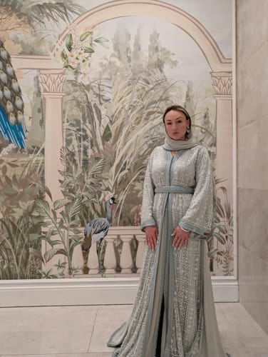 Customer showing the elegant fit of the embroidered Thesara Mint dress in a full-length view.