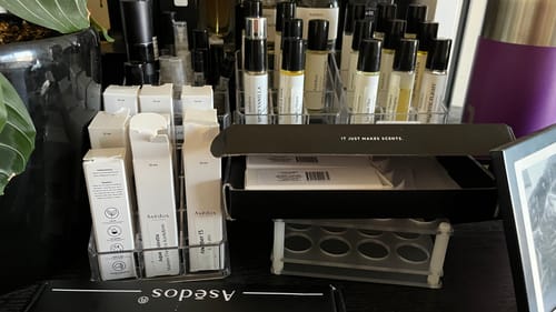 Reviewer's large collection of perfume oils, with Majestic Flight Perfume Oil among other scents on a shelf.