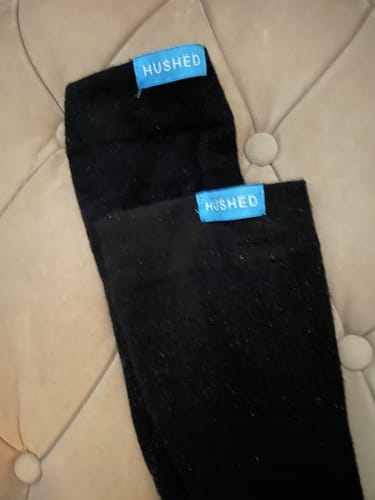 Customer's pair of black compression socks laid out, showing the bright blue tabs.