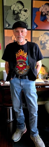 Reviewer standing while wearing the black Woodstock belt with blue jeans.