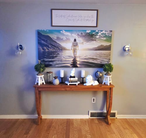 Customer's large Reflections Faith Wall Art hanging on a living room wall. The canvas depicts Jesus walking across the water.