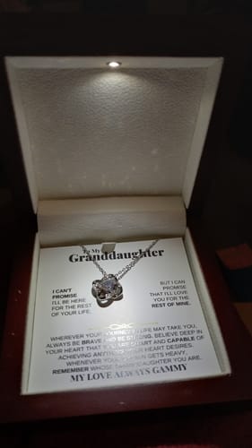 Reviewer's personalized gift set with the love knot necklace displayed in its illuminated mahogany-style box with a message card.