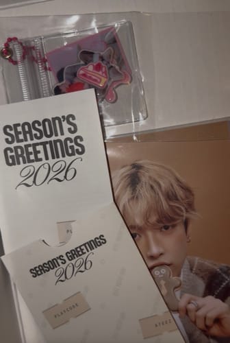 Customer's ATEEZ 2026 Season's Greetings packaging, photocard, and a clear pouch with a keychain inside.
