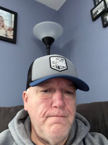 Customer provides a close-up view wearing the gray and blue Big Foam Trucker Hat.