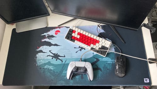 Reviewer's large Rogue Squad mousepad with a Star Wars design, displayed on a desk with gaming peripherals.