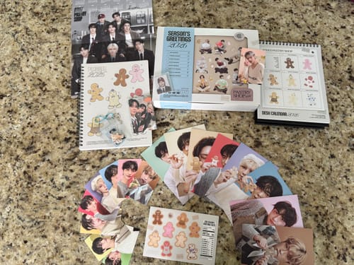 Customer's complete ATEEZ - 2026 SEASON'S GREETINGS set, including the planner, calendar, and photocards spread out on a counter.