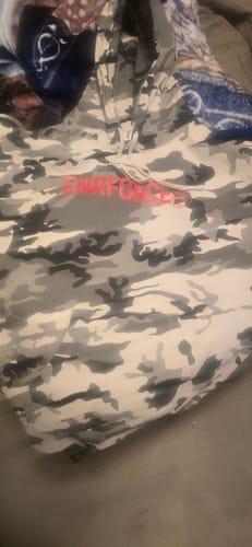 Close-up of a customer's Snow Camo Hoodie, showing the white and grey camo pattern and red logo.
