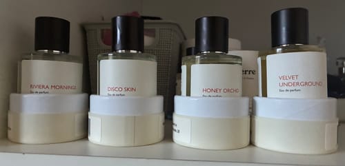 Customer's Riviera Mornings perfume bottle lined up with other scents on a shelf, showing their collection.