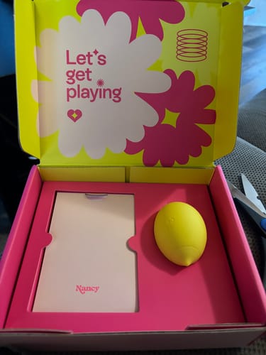 Customer's yellow, lemon-shaped Lem massager sitting in its colorful, open box.