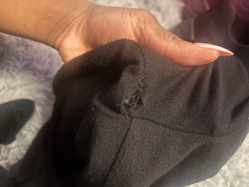 Close-up from a customer showing a hole and pilling in the armpit of their black NW Sculpt Jumpsuit.