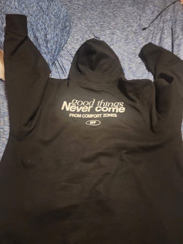 Customer's black hoodie laid flat, showing the 'good things Never come' text on the back.