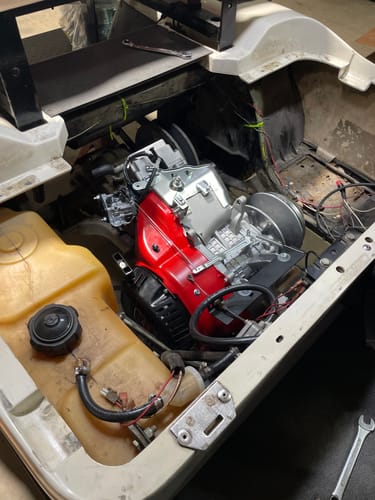 Customer's view of a new red engine installed in their golf cart using the EZ-GO conversion kit.