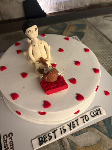 Customer's Adult Bachelor Party Cake with a risqué fondant topper, red hearts, and text reading 'BEST IS YET TO COM'.