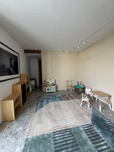 Customer's light wood KIDS PEEKABOO Cabinet shown in a child's playroom next to other wooden furniture.