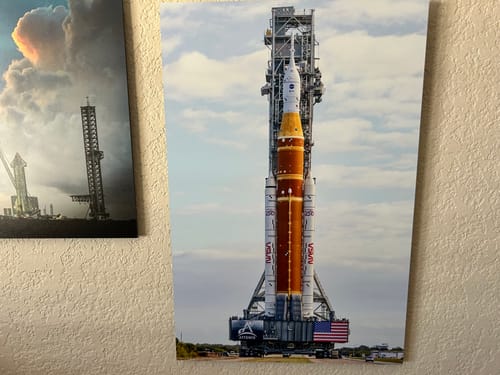 Customer's 'Padbound - SLS' print showing the tall rocket on its launchpad, hung on a wall.