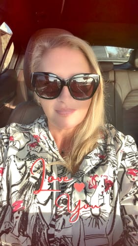 Reviewer's photo of the person who received their 'CREATE YOUR MELODY' song, smiling while sitting in a car.