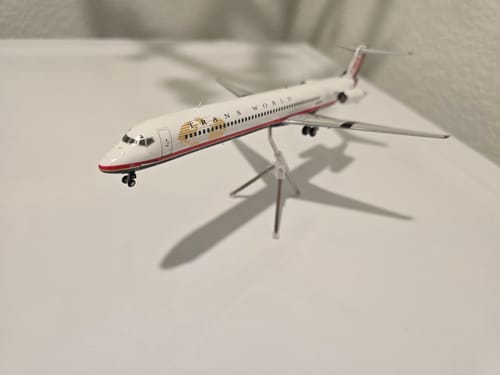Customer's GEMINI200 TWA MD-80 model airplane displayed on its clear stand against a white background.