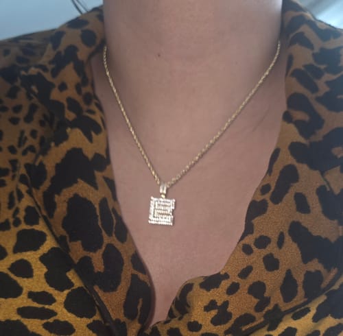 Customer wearing the 14k Initial CZ Pendant with a gold Hollow Rope Chain around their neck.