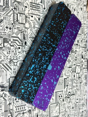 Customer's Weekly AM-PM Pill Case 2.0 with a black and purple splatter finish, shown magnetically connected.