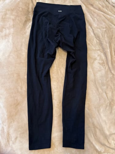 Customer's black Essentials Legging laid out, showing the V-dip scrunched back and waistband logo.