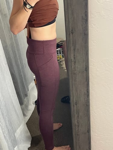 Reviewer's side view wearing purple Frost Duralite® Leggings, showing the high waistband and pocket.