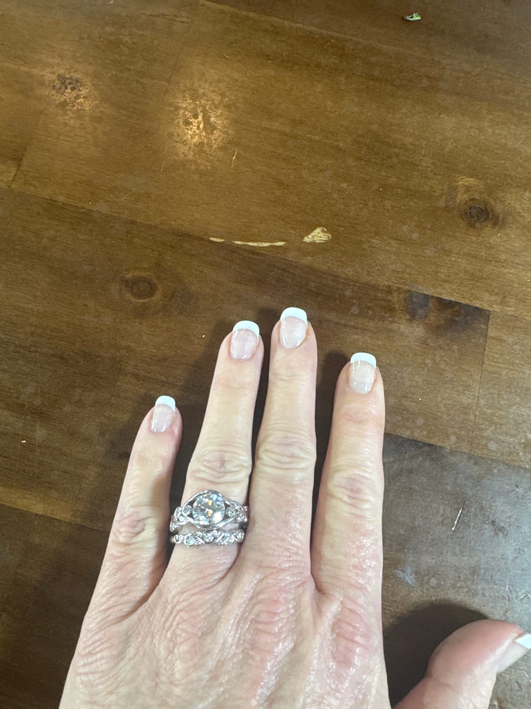 Customer photo review of Bezel Set Round Moissanite Scroll Accents Wedding Band Ring In Sterling Silver