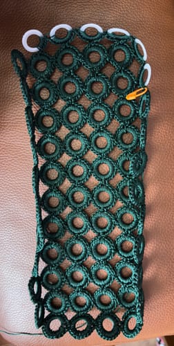 Customer's dark green crochet project in progress using the Garden Bee Crochet Bag Kit, showing the base.